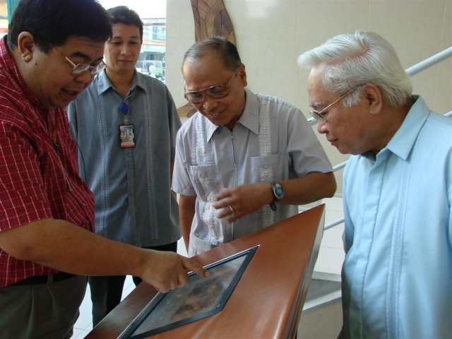 Pres. Malayang plays with the Interactive Screen while Macalolot, Agnir and Fontelo look on.